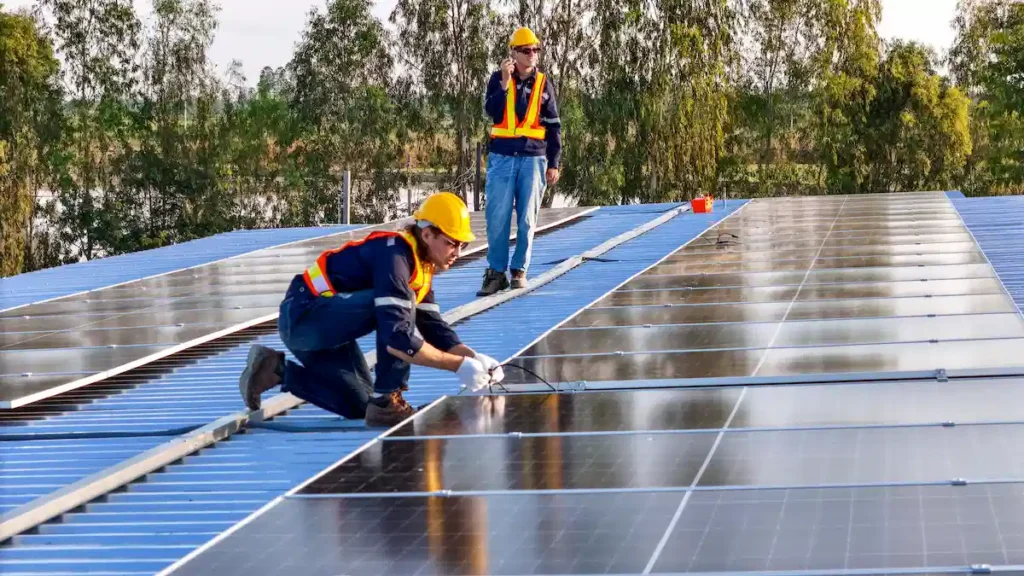 installers installing solar panels on roof