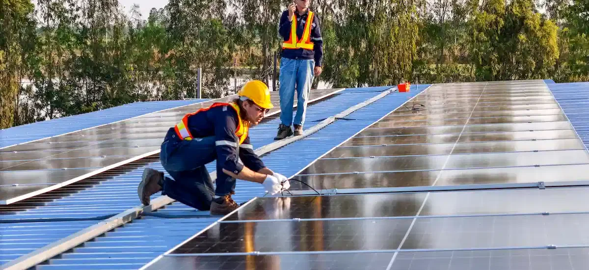 installers installing solar panels on roof