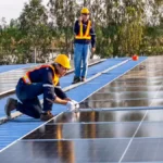 installers installing solar panels on roof
