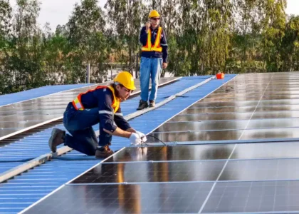 installers installing solar panels on roof