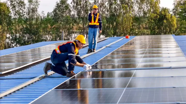 installers installing solar panels on roof