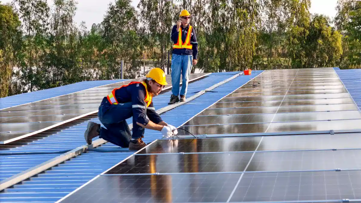 installers installing solar panels on roof