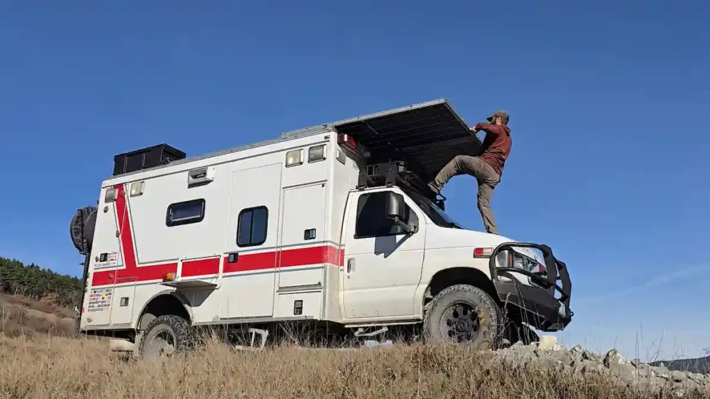 RVer pulling portable solar panels from a van while boondocking off-grid